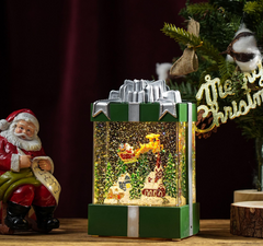 Felinar decorativ Craciun in forma de cadou, cu scena fixa si efect de ninsoare, lumina calda, 20 cm