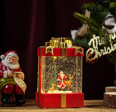 Felinar decorativ Craciun in forma de cadou, cu scena fixa si efect de ninsoare, lumina calda, 20 cm